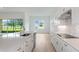 Bright kitchen with island, stainless steel dishwasher, cooktop, and views of the backyard at 8734 Sw 55Th Street Rd, Ocala, FL 34481