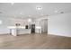 Open-concept living room and kitchen feature white cabinets, island, and stainless steel appliances at 8734 Sw 55Th Street Rd, Ocala, FL 34481