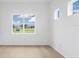 Bright, sunlit room with two large windows overlooking the lush greenery outside at 8734 Sw 55Th Street Rd, Ocala, FL 34481
