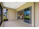 Covered patio with sliding glass doors leading to a modern kitchen, creating seamless indoor/outdoor living at 8734 Sw 55Th Street Rd, Ocala, FL 34481