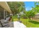 Serene backyard with lush greenery, a BBQ grill, and a screened-in porch at 1007 Cr 463B, Lake Panasoffkee, FL 33538