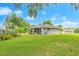 Spacious backyard with lush lawn, garden area, and plenty of space for outdoor activities and relaxation at 1007 Cr 463B, Lake Panasoffkee, FL 33538
