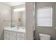 Bathroom with a white vanity, a mirror, and a window that allows natural light at 1007 Cr 463B, Lake Panasoffkee, FL 33538