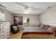 Cozy bedroom featuring a ceiling fan, a large painting, and a window at 1007 Cr 463B, Lake Panasoffkee, FL 33538