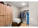 Walk-in closet with custom wood storage and shelving for optimal organization at 1007 Cr 463B, Lake Panasoffkee, FL 33538