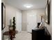Inviting entryway featuring a decorative table, artwork, and a well-lit, neutral color scheme at 1007 Cr 463B, Lake Panasoffkee, FL 33538
