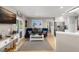 Living room featuring hardwood floors, nautical artwork, and an adjacent kitchen with stainless steel refrigerator at 1007 Cr 463B, Lake Panasoffkee, FL 33538