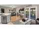 Light-filled living room with wood floors, sliding doors to outdoor space, and stainless steel dishwasher at 1007 Cr 463B, Lake Panasoffkee, FL 33538