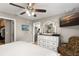 Main bedroom with ceiling fan, TV, ensuite bath, and walk-in closet at 1007 Cr 463B, Lake Panasoffkee, FL 33538