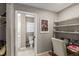 The office features built in shelving, a desk with office chair, and views into the en suite bathroom at 1007 Cr 463B, Lake Panasoffkee, FL 33538