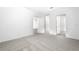 A bright bedroom features neutral carpet and doors leading to closet and other rooms at 13442 Leaping Water Way, Astatula, FL 34705