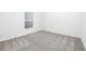 A vacant bedroom with neutral carpet and a single window at 13442 Leaping Water Way, Astatula, FL 34705