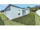 New construction home with white exterior and green lawn with trees in the background at 13442 Leaping Water Way, Astatula, FL 34705