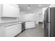 Bright kitchen showcasing granite counters, stainless steel appliances, and modern gray flooring at 13442 Leaping Water Way, Astatula, FL 34705
