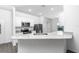 Well-lit kitchen with granite countertops, stainless steel appliances, and stylish gray flooring at 13442 Leaping Water Way, Astatula, FL 34705