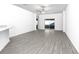 Spacious living room featuring contemporary gray flooring and access to the backyard at 13442 Leaping Water Way, Astatula, FL 34705