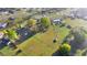 Aerial view showcasing the expansive property, lush greenery, and surrounding neighborhood at 5728 Ne 21St Avenue Rd, Ocala, FL 34479