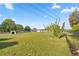 Sprawling backyard featuring lush green grass, mature trees, and a storage shed at 5728 Ne 21St Avenue Rd, Ocala, FL 34479