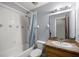 Bathroom featuring a shower over tub, light vanity, and coordinating finishes at 5728 Ne 21St Avenue Rd, Ocala, FL 34479