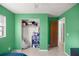Bedroom featuring a closet, neutral tile flooring, and view into the hallway at 5728 Ne 21St Avenue Rd, Ocala, FL 34479