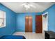 Comfortable bedroom featuring a closet, neutral tile flooring, and natural light from a window at 5728 Ne 21St Avenue Rd, Ocala, FL 34479
