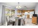Bright kitchen with wooden cabinets and a dining area with backyard views at 5728 Ne 21St Avenue Rd, Ocala, FL 34479