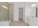 Bathroom with glass-enclosed shower, double vanity with quartz countertops, and walk-in closet at 8787 Sw 52Nd Place Rd, Ocala, FL 34481