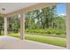View from a covered patio overlooking a lush green yard surrounded by trees at 8787 Sw 52Nd Place Rd, Ocala, FL 34481