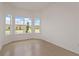 Empty room featuring a bright, sunlit space with ceramic tile floors and a trio of large windows at 8787 Sw 52Nd Place Rd, Ocala, FL 34481