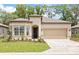 Charming single-story home with a manicured lawn, brick driveway, and a two-car garage at 8787 Sw 52Nd Place Rd, Ocala, FL 34481