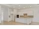 Bright, modern kitchen with white cabinets, quartz countertops, stainless steel appliances and center island at 8787 Sw 52Nd Place Rd, Ocala, FL 34481