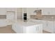 Bright, modern kitchen with white cabinets, quartz countertops, stainless steel appliances and center island at 8787 Sw 52Nd Place Rd, Ocala, FL 34481