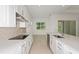 Bright kitchen with white cabinets, quartz countertops, stainless steel appliances and center island at 8787 Sw 52Nd Place Rd, Ocala, FL 34481