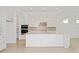 Bright, modern kitchen with white cabinets, quartz countertops, stainless steel appliances and center island at 8787 Sw 52Nd Place Rd, Ocala, FL 34481