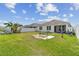 Enjoy the expansive backyard with lush grass, a swing set, and a hammock, perfect for Gathering fun and relaxation at 879 Killarney Ln, Auburndale, FL 33823