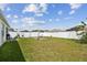 This private, fenced backyard features mature plantings, a hammock, and a swing set for relaxation and recreation at 879 Killarney Ln, Auburndale, FL 33823
