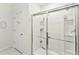 This bathroom features a glass shower with shelves for storing toiletries and a separate room labeled as a 'War Room' at 879 Killarney Ln, Auburndale, FL 33823