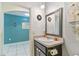 Powder room features a dark vanity with modern sink, decorative mirror, and neutral wall color at 879 Killarney Ln, Auburndale, FL 33823