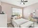 Inviting bedroom with neutral walls, wood-look flooring, plush bedding, and natural light from the window at 879 Killarney Ln, Auburndale, FL 33823
