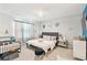 Cozy bedroom with neutral color palette, soft carpet, and stylish chandelier lighting at 879 Killarney Ln, Auburndale, FL 33823