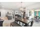 Open concept dining area includes kitchen, living room, patio access, and plenty of natural light at 879 Killarney Ln, Auburndale, FL 33823