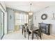 Dining room features a wooden table with seating for six and stylish pendant lighting at 879 Killarney Ln, Auburndale, FL 33823