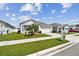 Lovely single-story home with lush green lawn, beautiful landscaping and an attached two-car garage at 879 Killarney Ln, Auburndale, FL 33823