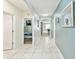 Bright hallway with tile floors, arched doorways, and neutral wall colors with a view to rooms at 879 Killarney Ln, Auburndale, FL 33823