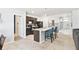 Modern kitchen with granite countertops, dark cabinets, stainless steel appliances, and a kitchen island at 879 Killarney Ln, Auburndale, FL 33823