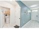 Hallway leading to a laundry room with a washer, dryer and custom white-washed wood accent wall at 879 Killarney Ln, Auburndale, FL 33823