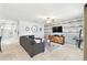 Spacious living room showcases a decorative accent wall, ceiling fan, and comfortable seating at 879 Killarney Ln, Auburndale, FL 33823
