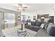 Open-concept living room with comfortable seating, natural light, dining area, and modern kitchen at 879 Killarney Ln, Auburndale, FL 33823