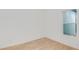 Sunlit bedroom with wood-look floors and a large window at 8980 Sw 52Nd Place Rd, Ocala, FL 34481