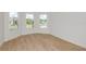 Light-filled bedroom with wood-look flooring and views of the surrounding neighborhood at 8980 Sw 52Nd Place Rd, Ocala, FL 34481